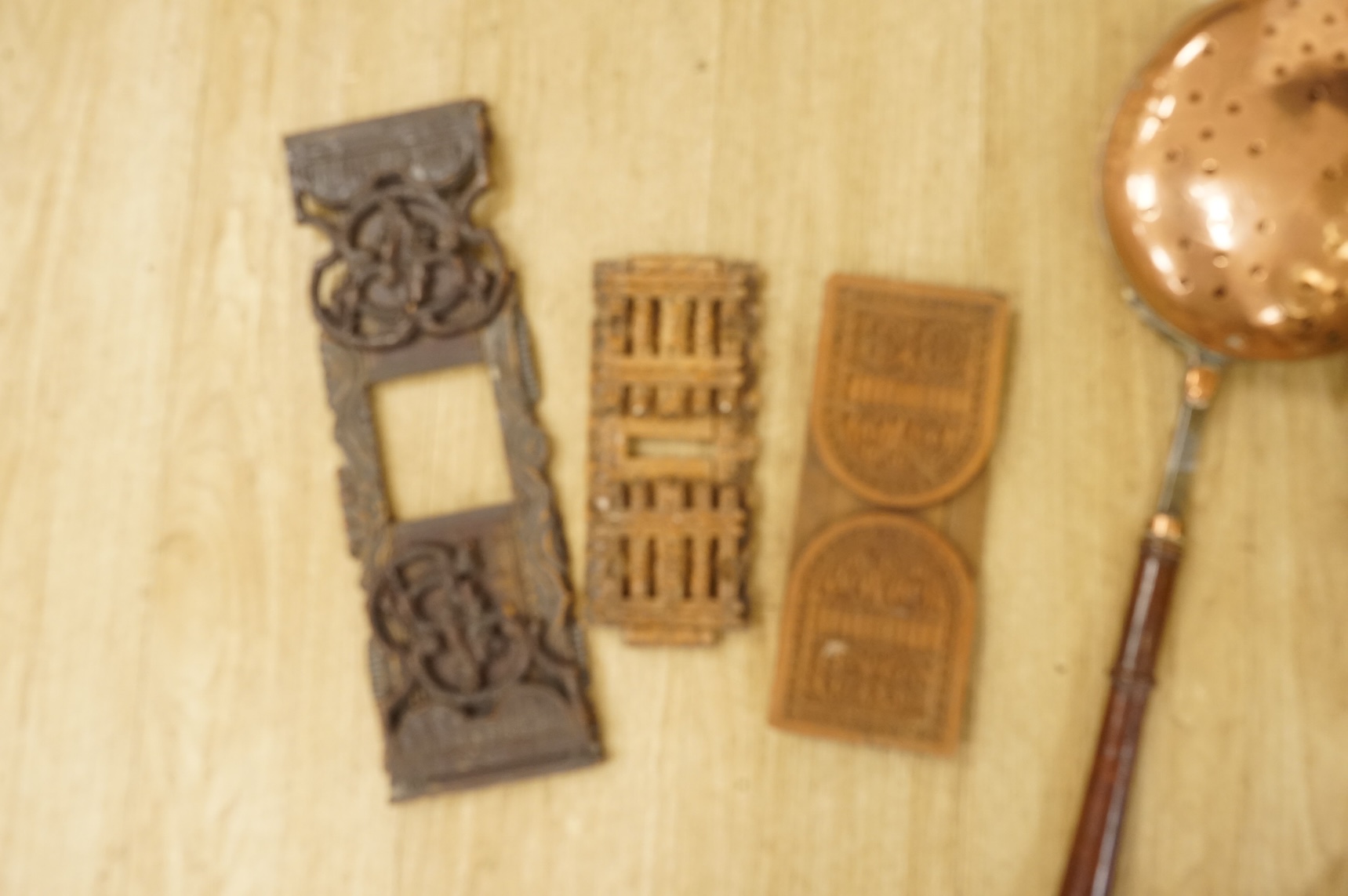 A 19th century Dutch brass coal bin, a pair of wall sconces, a copper bed warmer and three book slides